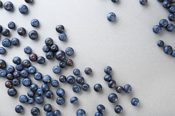 Many ripe blueberry on grey background