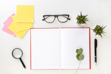 Composition with notebook and stationery on white background