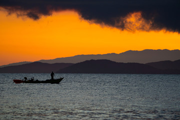 Fototapeta na wymiar Thailand sea in twilight time with Silhouette ship and fisherman in the sea