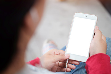 Cropped shot view of man hands holding smart phone with blank copy space screen for your text message or information content, female reading text message on cell telephone during in urban setting. 
