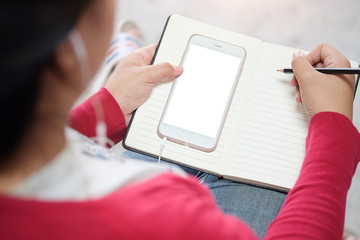 Cropped shot view of man hands holding smart phone with blank copy space screen for your text message or information content, female reading text message on cell telephone during in urban setting. 