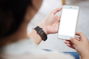 Cropped shot view of man hands holding smart phone with blank copy space screen for your text message or information content, female reading text message on cell telephone during in urban setting. 