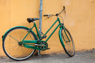 Naklejka na ściany i meble Parked bicycle at the beautiful streets of Pisa