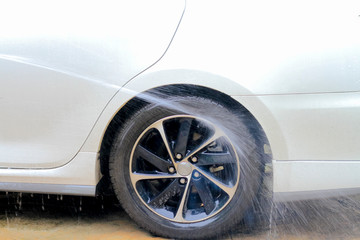 Obraz na płótnie Canvas washing car wheel after raining