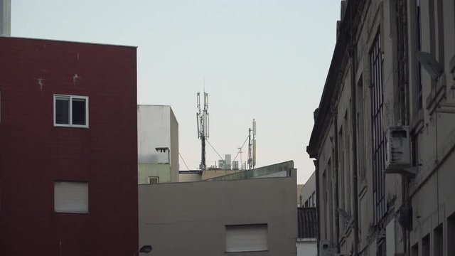 Communication antennas in top of a building in residential neighborhood, Porto, Portugal.