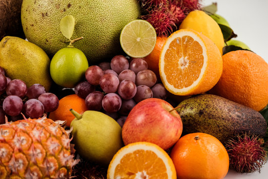 A heap of different tropical fruits isolated on white background. Healthy and organic fair concept. - Image