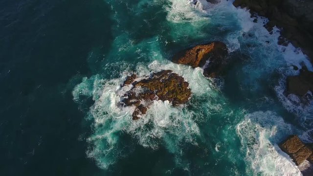 aerial shot of rocks crashing in ocean amazing landscape in the middle of the water rocks