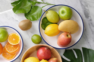 Tropical summer fruits assorted on white marble background. Fresh raw Healthy vegan food concept. Copy space top view - Image