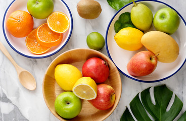 Tropical summer fruits assorted on white marble background. Fresh raw Healthy vegan food concept. Copy space top view - Image