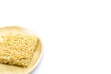 Famous dried instant noodles isolated on a wooden plate selected focus with white background and copy space. Horizontal shot.