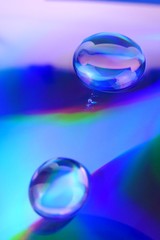 Drop macro background.Water drop on a deep blue iridescent background with gradation and highlights. Abstract blob texture .Phone wallpaper