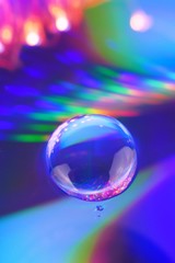 Drop macro background.Water drop on a deep blue iridescent background with gradation and highlights. Abstract blob  background.Phone wallpaper