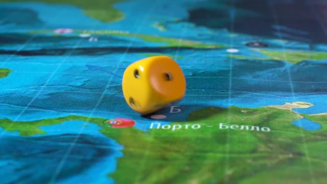 Hand throws yellow dice on the playing field. Gaming moments in dynamics. Concept of Board games.