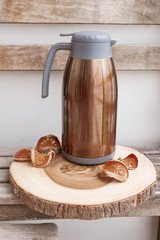 jug of tea  on wooden background. outdoor