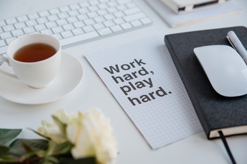 Workplace with a cup of tea and note. Motivation