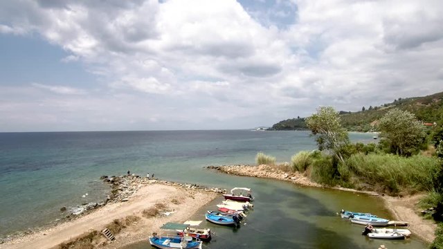 Aerial view of small natural harbor  in the area of Agia Paraskevi Halkidiki, Greece, move forward by drone