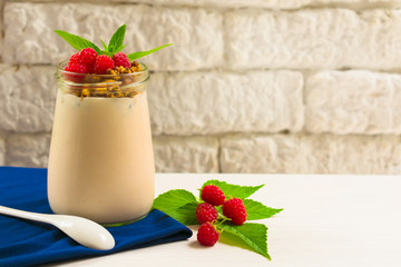 Granola yogurt decorated with fresh raspberry berries. Summer concept of healthy dessert, breakfast.