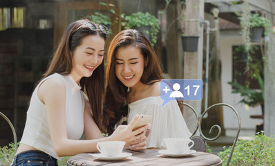 Two teenage women use smartphone play social media via smartphone with a lot of friend request