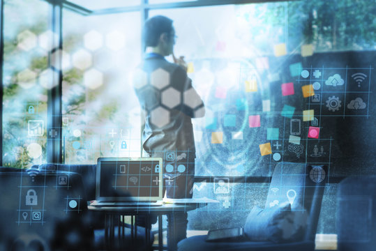 Businessman working with notes on glass wall alone in meeting room - Powered by Adobe