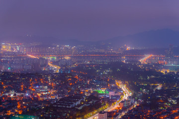 Naklejka premium The light of city in the mist of night time. Picture with grain and color from film simulation filter. 