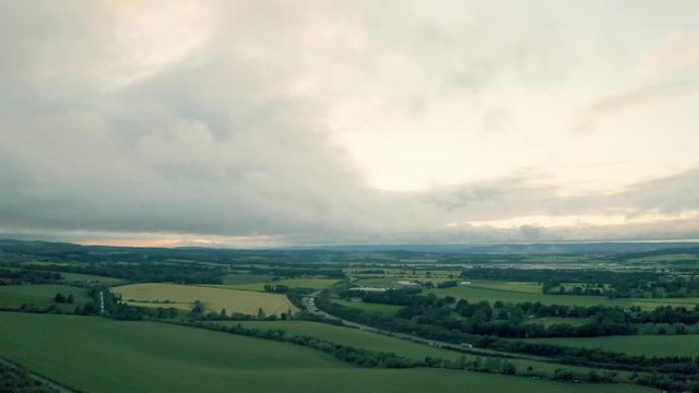 An aerial evening shot with the camera panning from high to low above a beautiful countryside  | Edinburgh | Shot in 4k at 30 fps