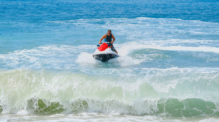 Man on jet ski jump on the wave