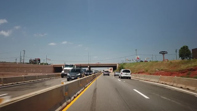 Hyperlapse through a construction site with few clouds and blue skies. The hills of the highway really show.