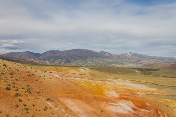 Red mountains in Kyzyl-Chin valley in Altay. Scenic landscape. Long shot. Summer concept.