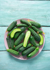 cucumbers in a bowl on wooden surface