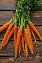 fresh carrots on wooden surface