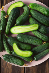 cucumbers in a bowl on wooden surface