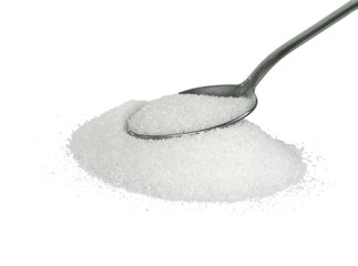 Heap of granulated sugar in a spoon isolated on white background.