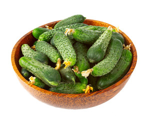 cucumbers in a bowl isolated on white