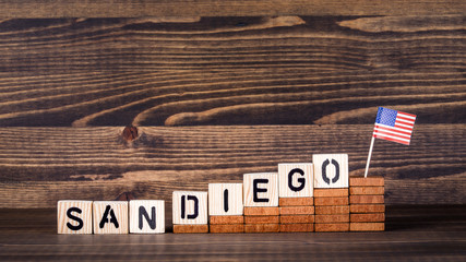 San Diego United States. Politics, economic and immigration concept. Wooden letters and flag on the office desk