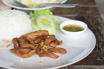 Fried pork with cooked rice.