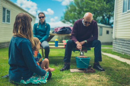 Multigenerational Family Enjoying Barbecue In Trailer Park