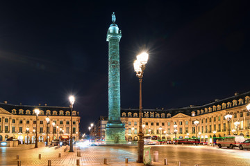 Fototapeta na wymiar ight view of Vendome Place with bronze column with bas-relief carvings topped by a statue of Napoleon. Copy space in sky.
