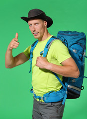 Traveler in hat and backpack showing thumbs up. Chromakey background - 277825942