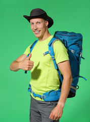 Traveler in hat and backpack showing thumbs up. Chromakey background - 277825969