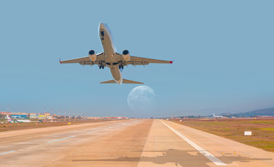 Airplane taking off from the airport with full moon "Elements of this Image Furnished by NASA"