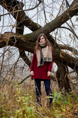 Girl in a red coat in the Park in late autumn