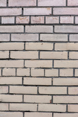 Old painted beige color weathered stained brick wall