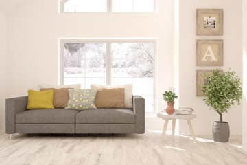 Stylish room in white color with sofa and winter landscape in window. Scandinavian interior design. 3D illustration