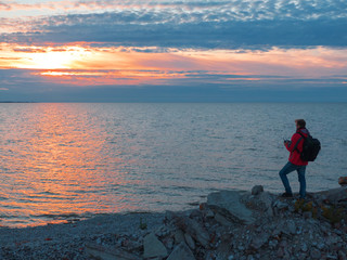 Fototapeta premium man at sunset by the sea.