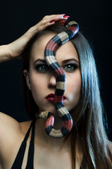 Perfect portrait green eyes sensual woman with king snake