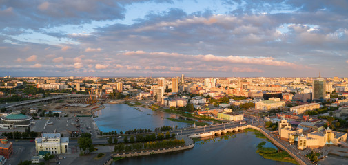 South Ural capital Chelyabinsk; summer evening with cloudy sky; drone flying forward to city center...