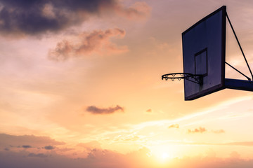 basketball basket against sunset sky