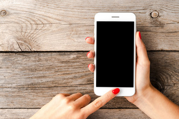 Woman using smartphone with empty black screen.