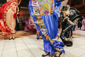 Gypsy dance festival, Woman performing romany dance and folk songs in national clothing. Beautiful roma gypsy girls dancing in traditional floral dress at wedding reception in restaurant