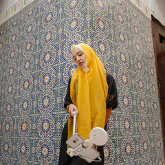 Tourist doind selfie in traditional riad - Fez, Morocco
